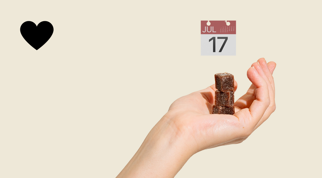 Three gummies stacked in the palm of a hand with a calendar icon.